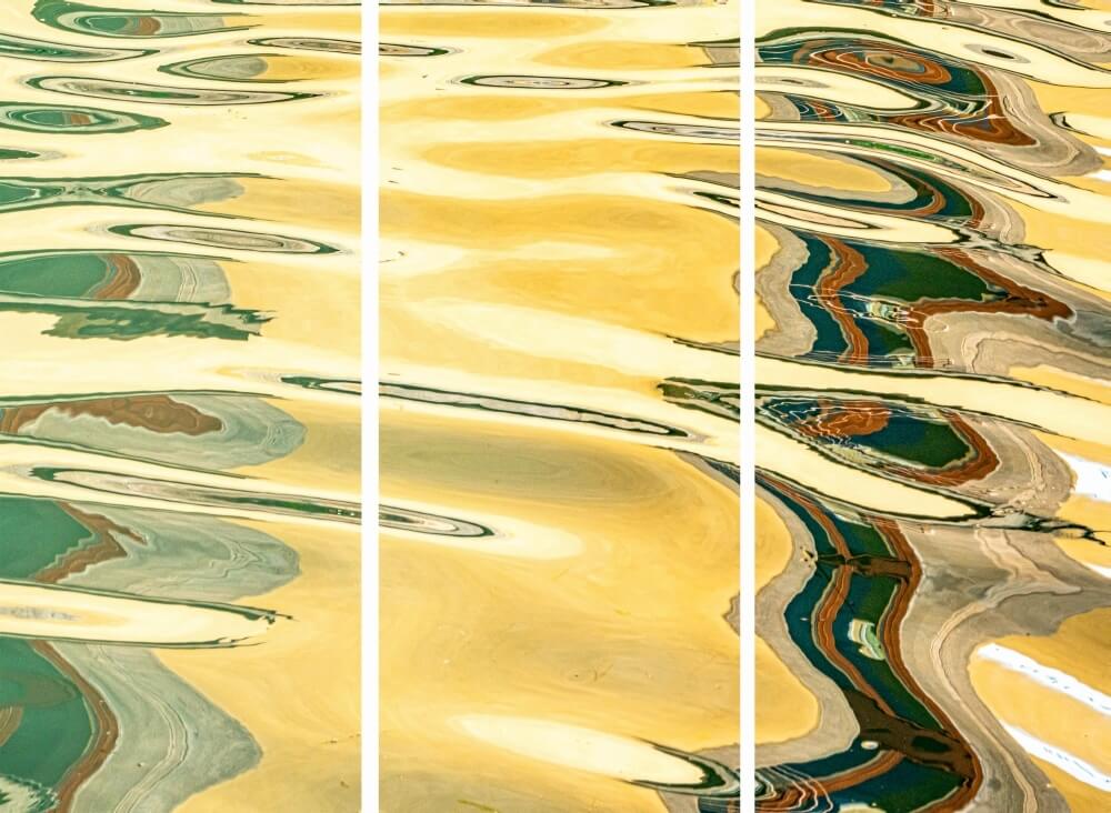 Galerie Ahlemann zeigt ein abstraktes Foto des Fotokünstlers Mick Schäfer aus der Serie "Reflecting Venice", auf dem Wasserreflektionen in überwiegend gelben, grauen, grünen und weißen Farbtönen zu sehen sind, als Triptychon.